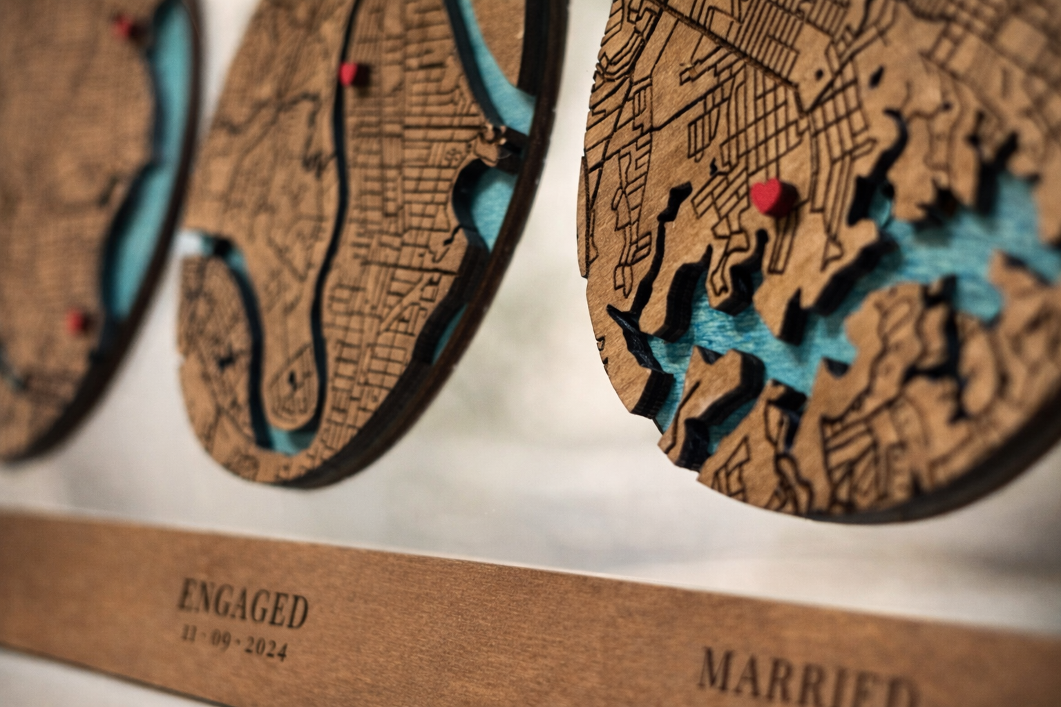 Close up of layered wooden map showing engraved street details and coloured water layers in personalised timeline map